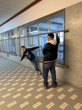 Zwei Jungs die vor einer Fensterfront stehen