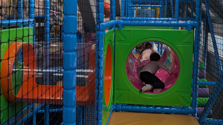 Zwei Kinder kriechen durch Tunnel