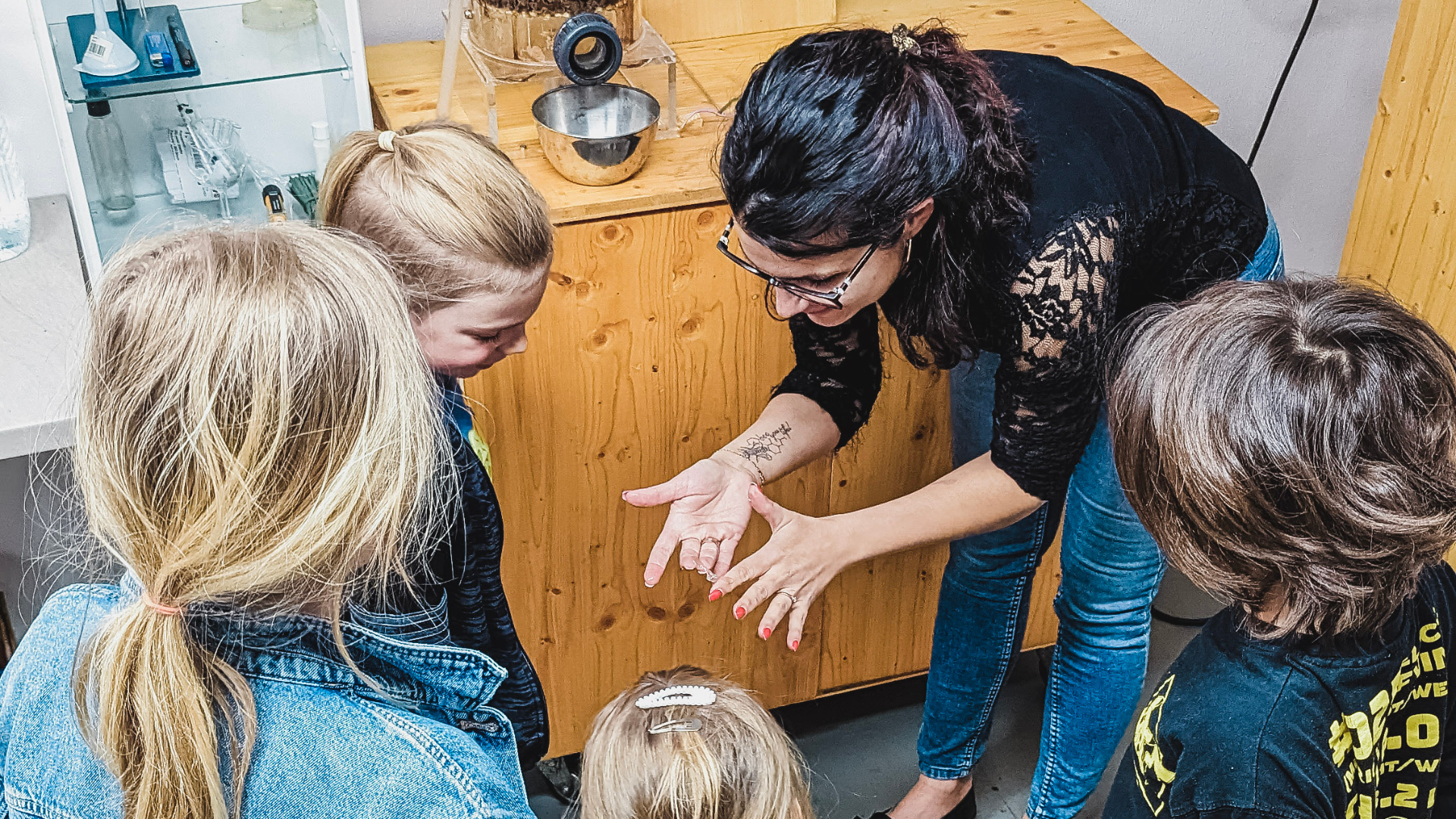 Frau erklärt Kindern Honig